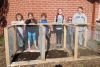 Students at Loughborough Public School stand in front of the new three-chamber composter that was recently constructed there