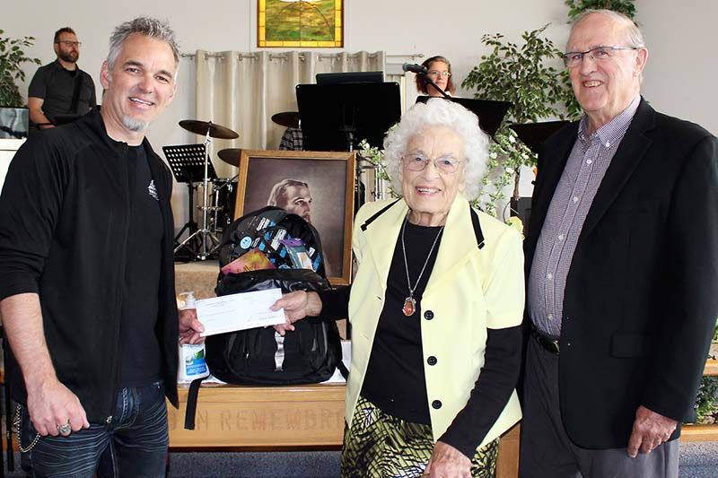 Clara Snook and Pastor Carl Bull present a check to Doug van der Horden for $6,000 that will provide First Response Bags to victims of human trafficking in the area. Photo/Craig Bakay