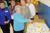 former long time school care taker Bernice Gunsinger of Plevna cut the anniversary cake at CCPS&#039;s 50th Anniversary celebrations on April 12