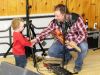 The next generation? Shawn McCullough gets congratulated by grandson Porter Badour during a gig last Sunday at the Sharbot Lake Legion with brother Dave. Photo/Craig Bakay