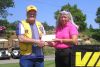  Lion Marvin Green presenting the $500 VIA Rail Voucher to the winner of the Putting Contest, Laurie Newport.