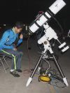 Louis Zhang from Ottawa has a look through Tim Trentadue’s telescope Saturday night in Fernleigh. Photo/Craig Bakay
