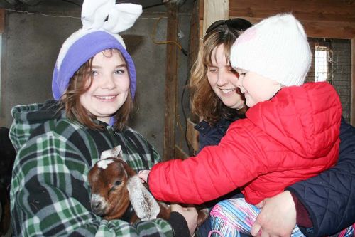Stella Chenier and Mom Tanya enjoyed meeting the young goat Daisy and her handler Dustine Waller at Five Star Farm’s Easter Family Fun Day. The Cheniers were visiting from Gananoque. Photo/Craig Bakay