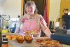 Bonnie Palmer with muffins, cinnamon buns, and tarts