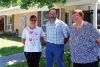 Christa Sheridan, Larry Pick, ad Linda Hume in front of the URCA senior&#039;s townhouse