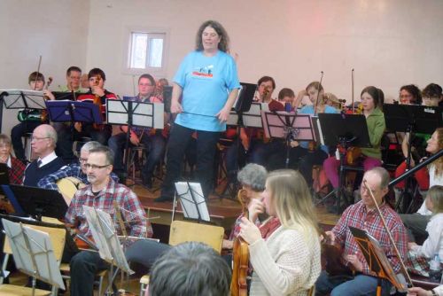 indy McCall leads the Blue Skies Community Fiddle and Prep orchestras at their annual Christmas Concert in Maberly where they were joined by the Celtic Heritage Fiddle Orchestra as well