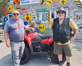 Bob Richardson presents Mario Pietrangelli withhis new ATV
