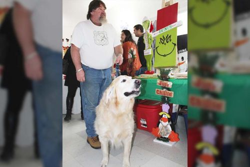The sign says ‘just chillin’ and that’s what therapy dog Buddy was doing with his crafting companion Tony Farrell of Tony Farrell Woodcrafts.