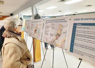 A resident looks at boards with the findings of the water and wastewater servicing study at the last Verona Housing Master Plan open house.