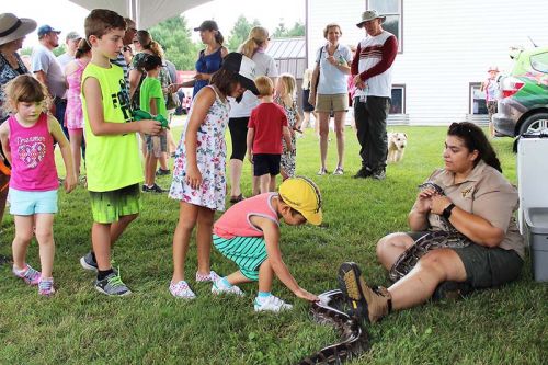 Alyssa Mullen of Little Ray’s Reptile Zoo held Bernie the Burmese python for kids to pet if they wanted to. Photo/Craig Bakay