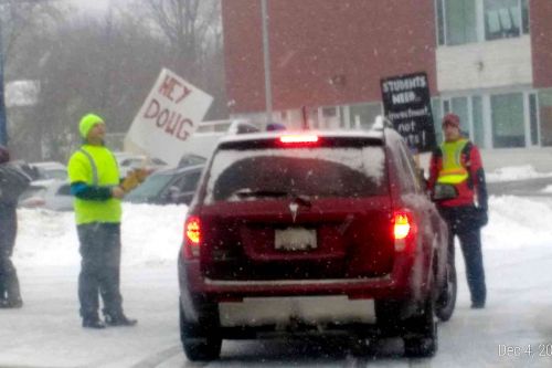Picketers holding car carrying elementary students for two minutes at the entrance to GREC on Wednesday morning