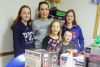 Rachel, Myh, Maddison, (back row) and Anna and Cooper (front row), pose in front of some of the items that were auctioned off at the Snow Road Snowmobile Club&#039;s dinner and Chinese auction fundraiser on January 16.