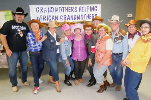 Members and supporters of Grandmothers by the Lake kick up their heels at their “Down Home Country Fun” fundraiser in Verona on October 5