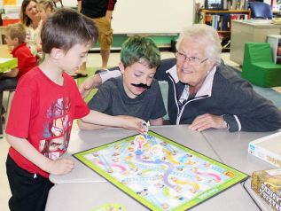 Ina Emmons played Snakes & Ladders with grandson Tyson Revelle and his buddy Abel Mulder-Kane at Prince Charles Public School’s Grandparents & Games afternoon last Thursday. Photo/Craig Bakay