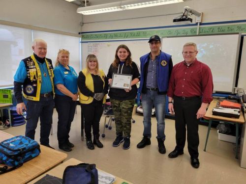 Pictured from left: Lion Jean Jacques “Red” Emond, Lion Sandra Carman, Lion Tammy Whitelock, student Abby Weiss, Lion Mike Hage, Principal John Mooney.