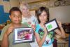 Ms. Thayer and two of her grade five students, Andrew Johnston and Kate Livie with the final projects they completed using the iPads the school acquired through an LLF grant