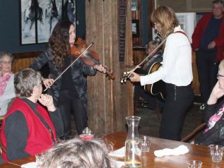 Lisa MacIsaac and Brenley MacEachern delighted the audience by circulating among them during their encore Friday night at The Crossing Pub in Sharbot Lake. Photo/Craig Bakay
