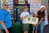 Faye Wan and Monica Bacon of Sandy Pines Wildlife Centre in Napanee with young supporters Aidan and Lauren Kiser of Ottawa at Frontenac Outfitters near Sydenham