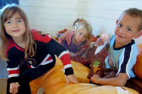 Michaela Leckey, Audrey Wright and Rapha Tsun frolic in the giant pumpkins.