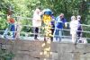 CARE members Judy McClure and Doug Scott dump 200 ducks from the Bridge Street bridge in Arden for their annual duck race fundraiser