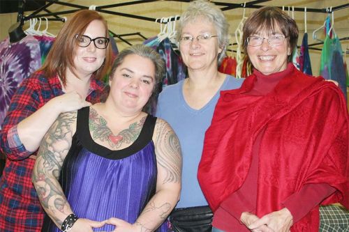 The Christmas Market at Prince Charles Public School in Verona Saturday was a combined effort of the PCPS School Advisory Council represented here by treasurer Tina McHale and chair Alison Williams and the Frontenac Farmers Market represented by outgoing chair Debbie Harris and incoming chair Laura Simmons. Photo/Craig Bakay