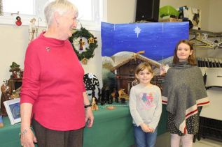 Kaitlyn Wight and Marie Choquette with Mary Murphy at the 12th annual St. Patrick’s Church Nativity Display last Sunday. Photo/Craig Bakay