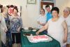 Karen Anderson cuts the cake officially opening the Kuriosity Shop in Northbrook Saturday. Photo/Craig Bakay