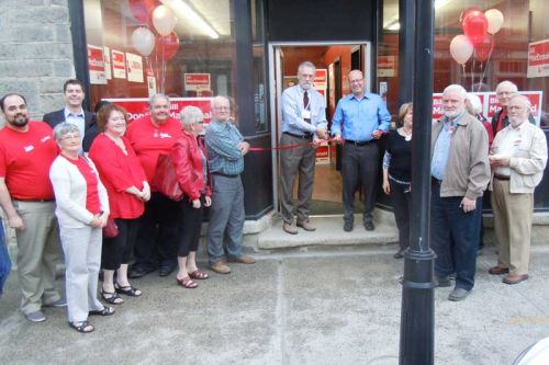 Liberal MPP candidate for Lanark Frontenac Lennox and Addington Bill MacDonald (right) cuts the cake at his new campaign office in Perth with the help of Perth Mayor John Fenik