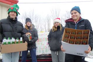 L-r local students Jack and Alex Revell, Allison Ewart, and Colby Dowker collected empty bottles at the VCA's Christmas for Kids bottle drive at the LCBO in Verona on November 29