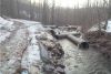 Pipes floating down Anderson Road after the flood.