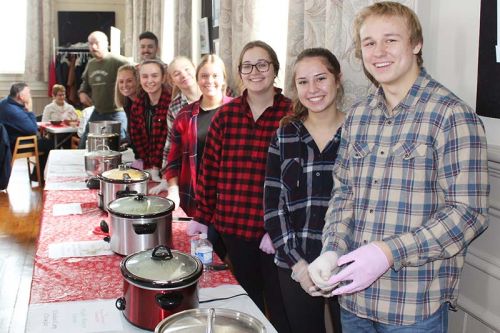 Who wouldn’t want a bowl of soup from this lineup of smiling volunteers? Photo/Craig Bakay
