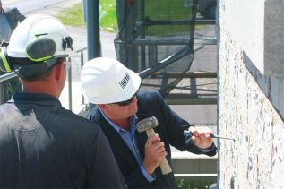 Careful Randy, you don't want to hurt the building, or your hands. Craig Beattie supervising MPP Randy Hillier in the ceremonial first pointing of the Grace Centre in Sydenham
