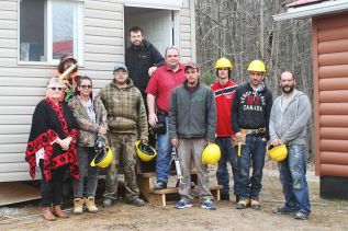 Work crew with Chief Davis in front of the new shed at the band office of the Shabot Obaadjiwan near Arden. Kevin Rioux (far right) Chief Davis (far left)