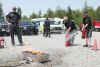 Coun. Gerry Martin and Mayor Ron Higgins take a turn at putting out a fire with extinguishers. The extinguishers demonstration was provided by Capt. Brian McCarthy, firefighter A.J. Watson and firefighter Jacob Green of the South Frontenac Fire Department.