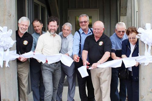 Both sitting and former politicians lined up to cut the ribbon on the revamped Township office in Plevna including (from left) Mayor Ron Higgins, Coun. John Ingles, MP Scott Reid, Coun. Vernon Hermer, MPP Randy Hillier, Coun. Gerry Martin, and former Council members Dave Smith and Barb Sproule. Photo/Craig Bakay