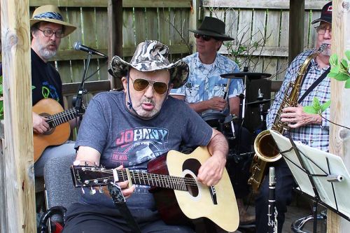 Morel Chaisson sat in with the band (Brian Roache, Derrick Roache and Al Kitching) as Community Living North Frontenac held its annual Backyard Barbecue for the community last Friday in Sharbot Lake. Photo/Craig Bakay
