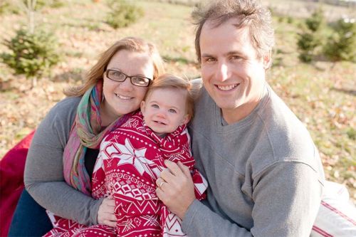 Amanda and Jeff surrounding the real apple of their eye, daughter Lily