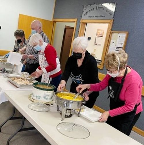 Volunteers portion out Christmas dinner at the Verona Lions Hall.