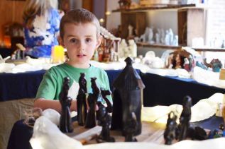 Carson Craven behind one of the African Nativity scenes on display