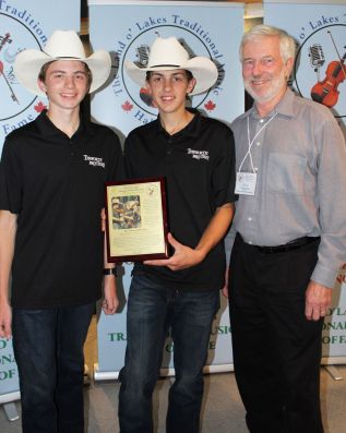 The Tebworth Brothers, Wyatt and Marshal, pictured with Frontenac County Warden Ron Higgins, were the Horizon Award winners for 2019
