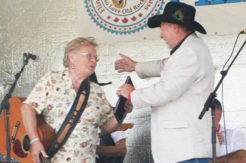 Bill White, himself an inductee this year, inducts Sheila Calthorpe into the Land O’Lakes Traditional Music Hall of Fame Saturday in Flinton.