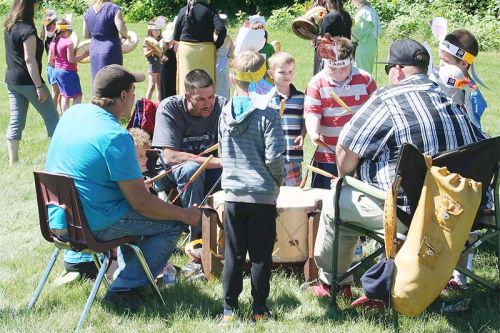 A popular stop at the Strawberry Moon Festival was the drumming station where the girls joined the women’s hand drums and the boys became part of the Red Sun men’s group. Photo/Craig Bakay