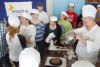 Chef professor Thomas Elia shows students at Prince Charles PS how to frost a chocolate cake they prepared in a slow cooker as part of the Slow Cooker For Kids pilot project