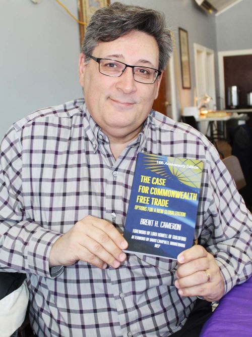 Author Brent Cameron shows his book, which has just come out with a 14th anniversary issue. Photo/Craig Bakay