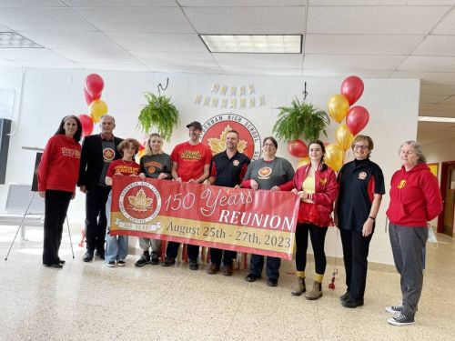 Staff, students & alumni unfurl a banner celebrating the 150 Anniversary of Sydenham High School.