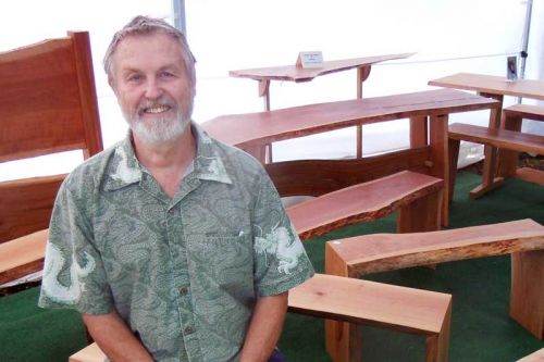 Ompah wood worker and furniture designer Peter Bunnett with some of his live edge furniture at the Sundance Artisan Festival in Maberly