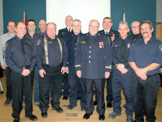 South Frontenac formally recognized South Frontenac Fire and Rescue firefighters who have recently retired from dedicated service and those that have achieved service medals for exemplary service at its regular meeting Tuesday night in Sydenham. Pictured with Chief Darcy Knott and Mayor Ron Vandewal are retirees Capt. Brian McCarthy (39 years of service), FF Alden McLellan (8 years), FF David Fitzerman (3 years), FF Peter Fraser (10 years), Rob Ryan (8 years) and Allison Oldendorp (absent). Medal recipients are: Mark Dermott (Fire Services Exemplary Service Medal for 20 years of loyal service), Richard Harper (First Bar to the Fire Services Exemplary Service Medal for 30 years of loyal service), William Jones (Second Bar to the Fire Services Exemplary Service Meal for 40 years of loyal service), Brian McCarthy (First Bar to the Fire Services Exemplary Service Medal for 30 years of loyal service), Michael Noonan (First Bar to the Fire Services Exemplary Service Medal for 30 years of loyal service), Michael Stanton (Fire Services Exemplary Service Medal for 20 years of loyal service), Steven Young (First Bar to the Fire Services Exemplary Service Medal for 30 years of loyal service and the Fire Services Exemplary Service Medal for 20 years of loyal service), and Ken Peters (absent, Fire Services Exemplary Service Medal for 20 years of loyal service). Photo/Craig Bakay