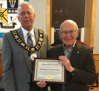 Mayor Andewal presenting a plaque to Duncan Sinclair