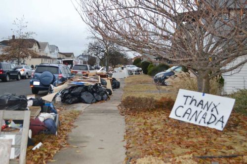 Contents of people’s homes that have to be discarded. Every street looked like this and some were much worse. The sign against the tree was one waiting as we pulled up to my parents’ house. Most, if not all of the cars on the street and throughout town were complete write-offs due to flooding.