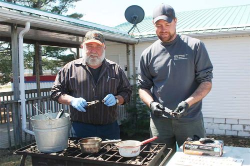 Wilf Deline and MNRF senior IRM technical specialist Graham Branscombe prepare fisher teeth for analysis. Photo/Craig Bakay